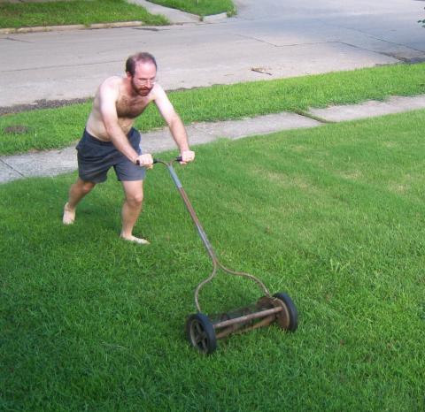 Ben mows the front yard with a reel mower
